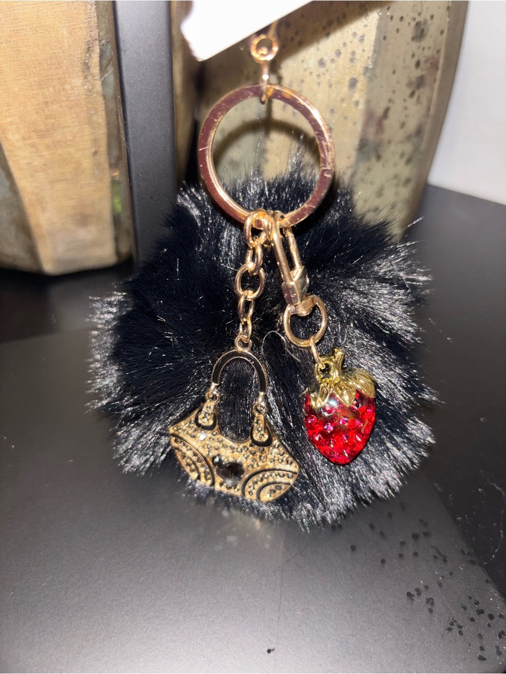 Gold-Tone Black Pom Pom Keychain with Red Strawberry Charm